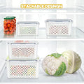 Stackable food storage containers with a cauliflower and onion on a refrigerator shelf.